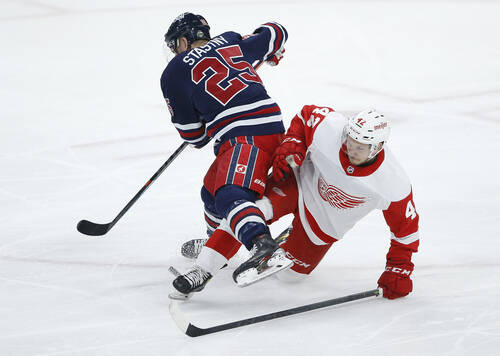 Winnipeg Jets’ Paul Stastny and Detroit Red Wings’ Kyle Criscuolo collide during the second period. THE CANADIAN PRESS/John Woods
