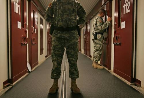 Brennan Linsley / The Associated Press files
In this 2007 photo, U.S. military personnel inspect occupied cells at Guantanamo Bay U.S. Naval Base in Cuba, where suspected terrorists were tortured by CIA operatives.