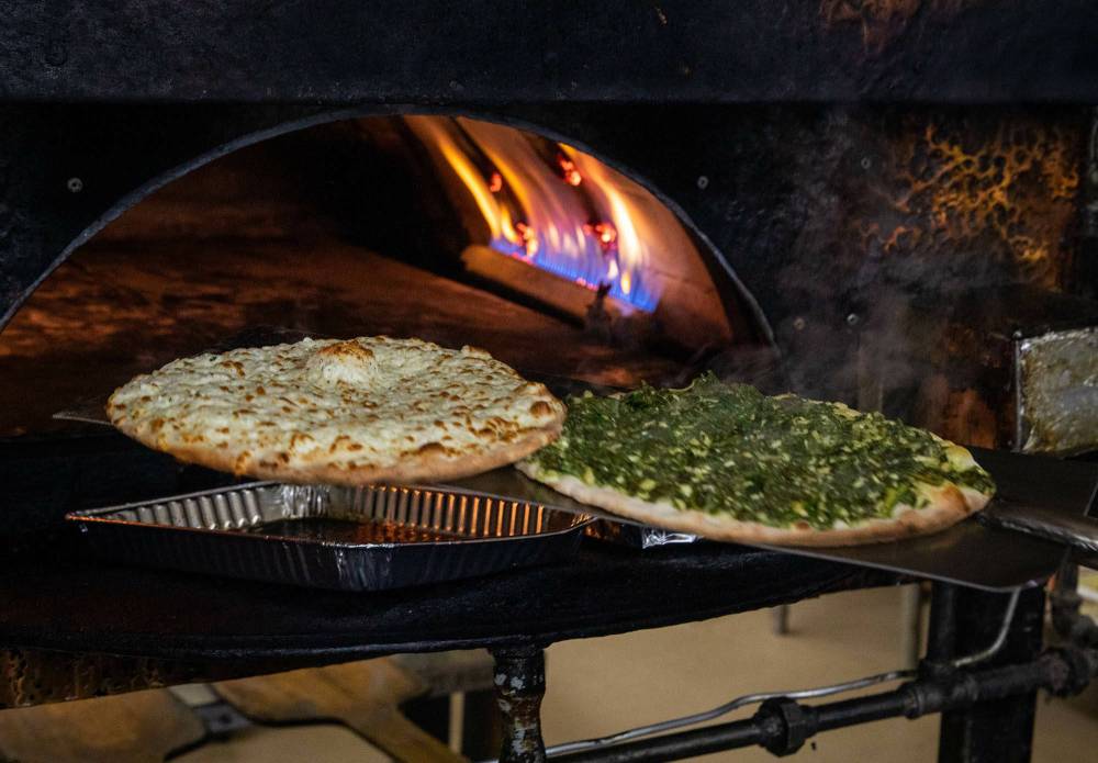 Pita pies go into the oven on a regular basis. (Jessica Lee / Winnipeg Free Press)