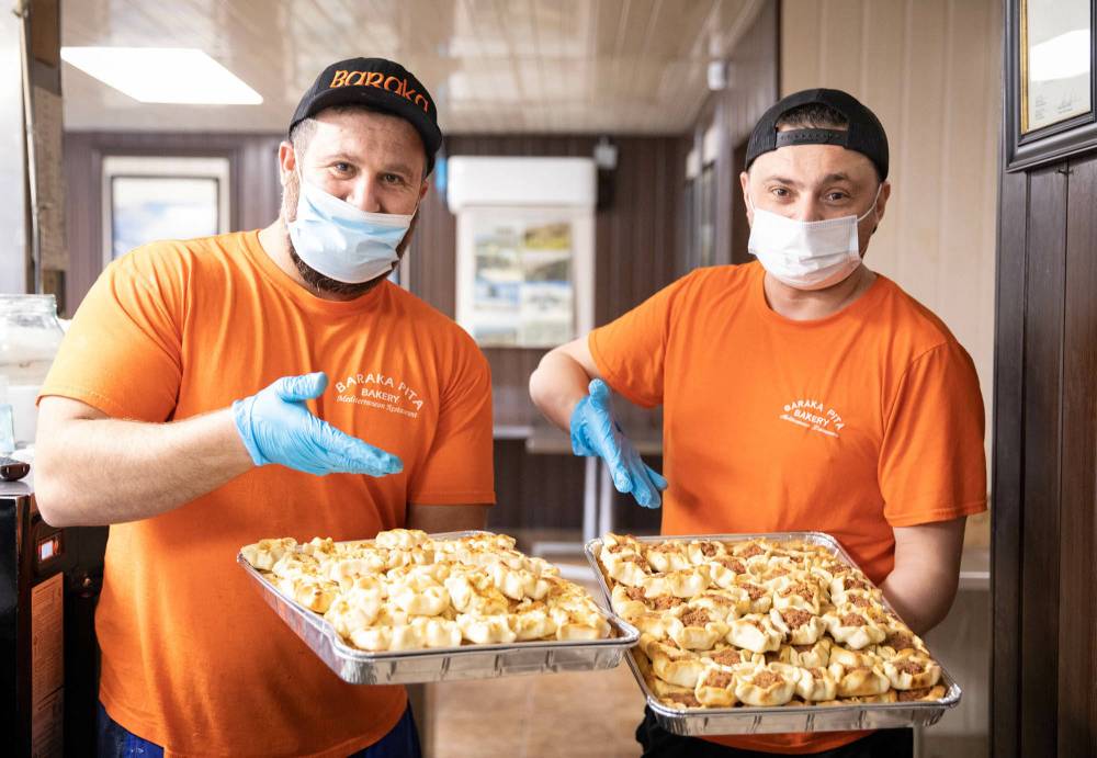 Saeed Aboumrad (left) and Alaa Trabolsi display the fatire at Baraka Bakery. (Jessica Lee / Winnipeg Free Press)