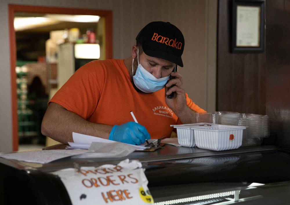 Saeed takes phone orders. (Jessica Lee / Winnipeg Free Press)