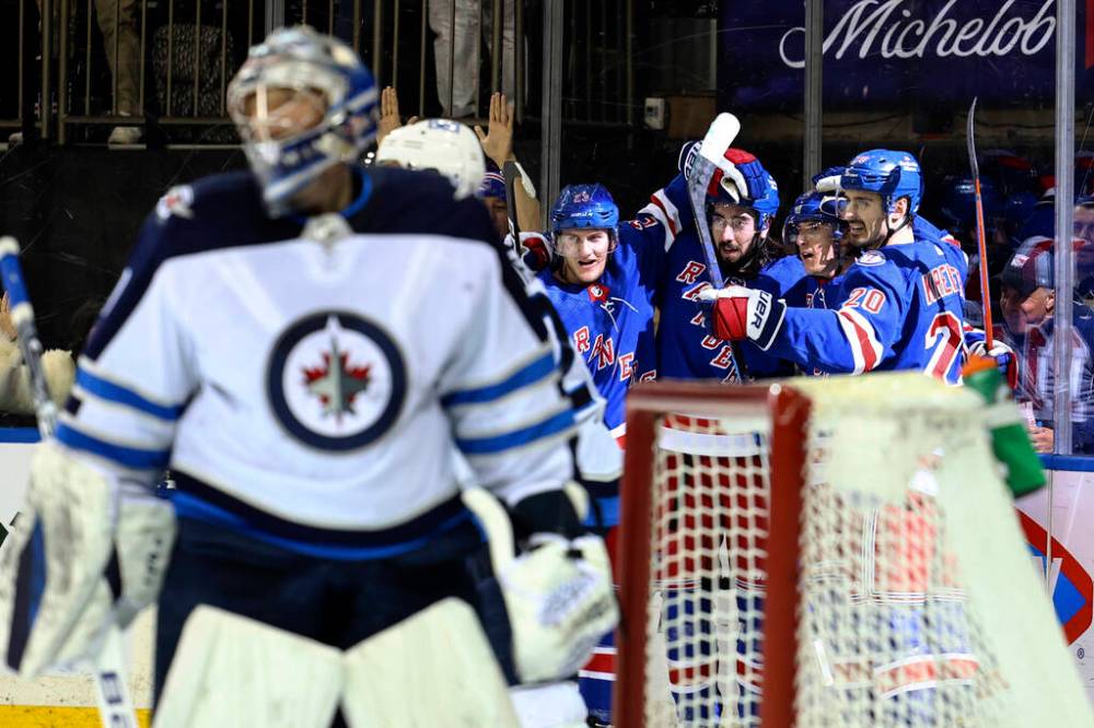New York Rangers’ Adam Fox, Mika Zibanejad, Ryan Strome and Chris Kreider celebrate a goal by Strome against the Winnipeg Jets during the second period Tuesday in New York. (AP Photo/Jessie Alcheh)