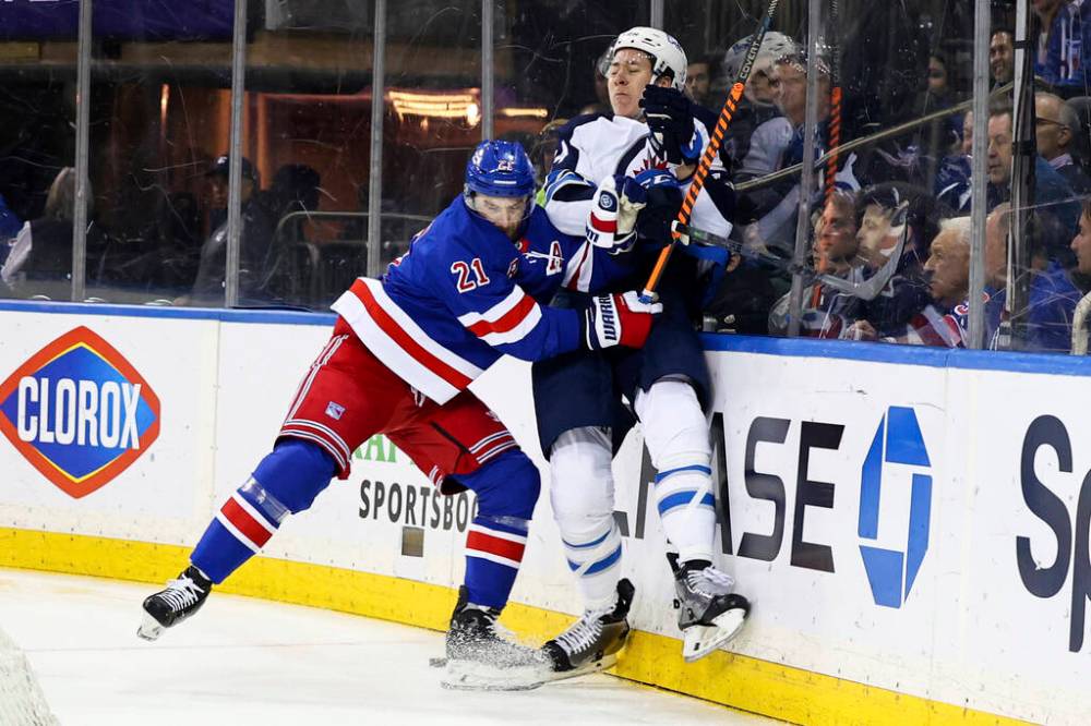 New York Rangers’ Barclay Goodrow checks Winnipeg Jets’ Logan Stanley into the boards during the second period. (AP Photo/Jessie Alcheh)