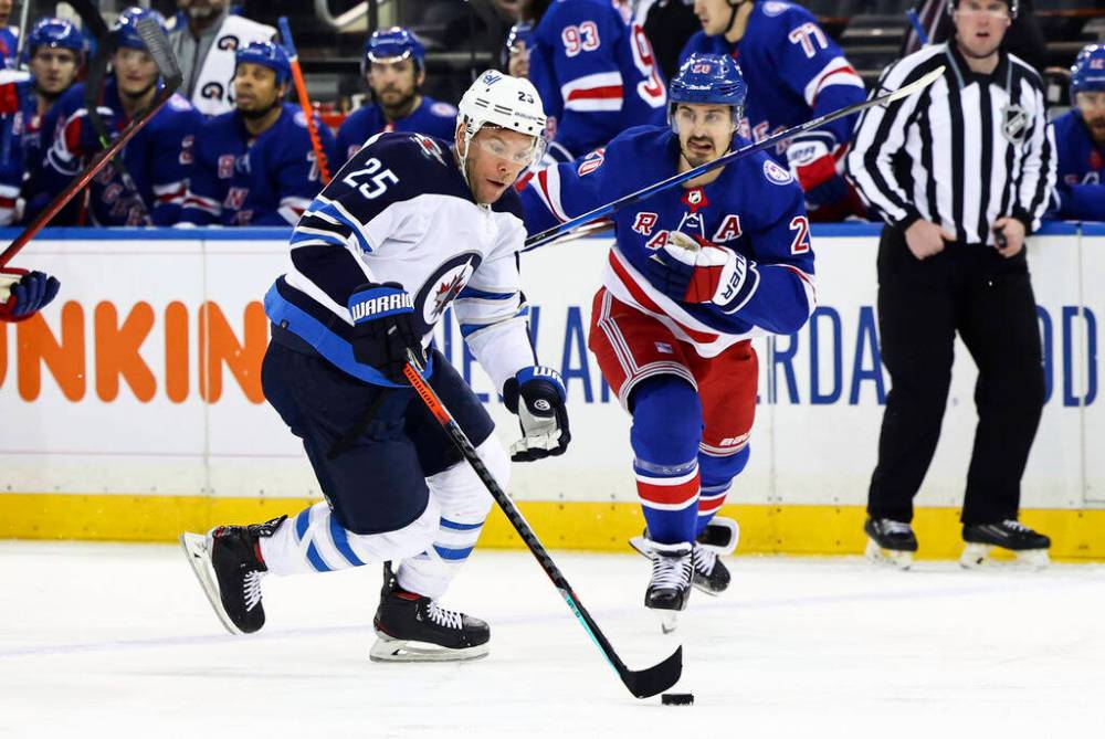Winnipeg Jets’ Paul Stastny skates with the puck against New York Rangers’ Chris Kreider during the first period. (AP Photo/Jessie Alcheh)