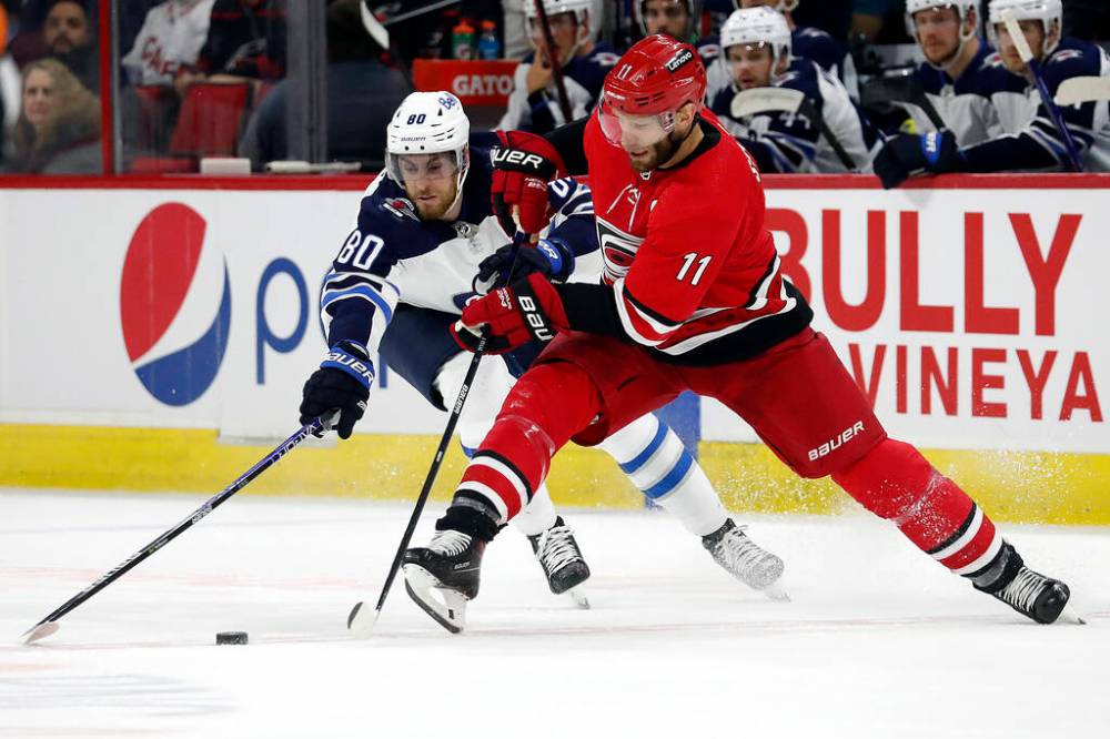 Carolina Hurricanes’ Jordan Staal controls the puck next to Winnipeg Jets’ Pierre-Luc Dubois during the first period. (AP Photo/Karl B DeBlaker)