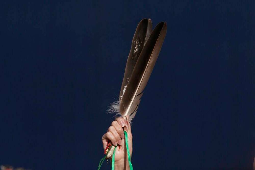 ADRIAN WYLD / THE CANADIAN PRESS FILES
Eagle feathers are held up during the National Day for Truth and Reconciliation in Ottawa on Sept. 30, 2021.