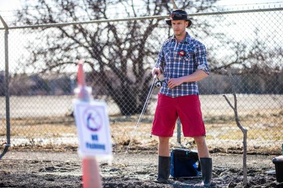 Chris Thompson had no trouble reeling in the laughs when he cast a fishing line into a giant pothole on Route 90 Wednesday. (Mikaela MacKenzie / Winnipeg Free Press)Thompson cast a lure into the depths of a sizable pothole