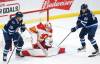 Calgary Flames goaltender Dan Vladar saves a deflection by Winnipeg Jets’ Pierre-Luc Dubois during the first period in Winnipeg, Friday. THE CANADIAN PRESS/John Woods