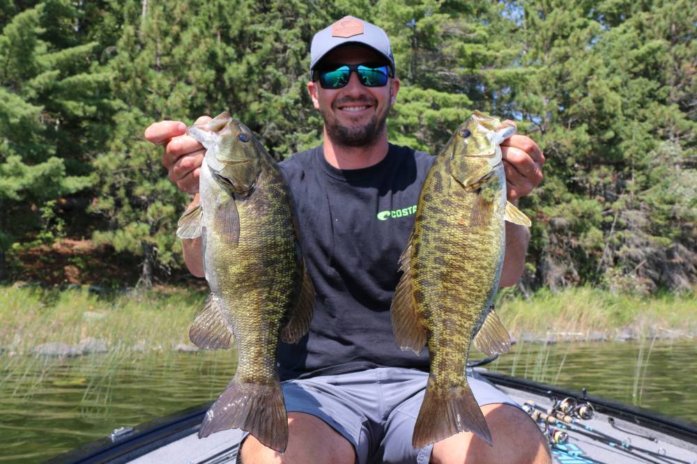 Supplied photos
Pro angler Jeff Gustafson with two smallmouth bass caught on hair jigs.