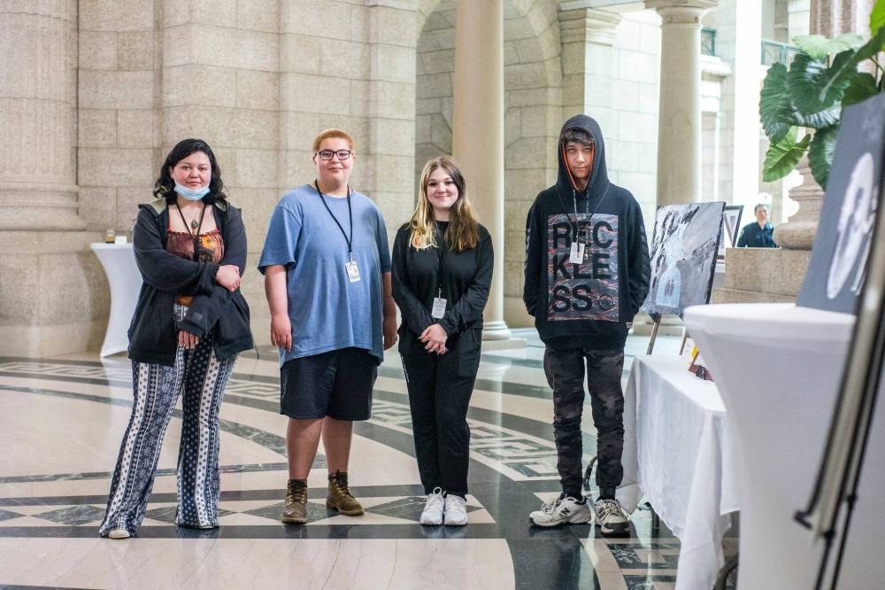 Argyle Alternative High School students Ricki-Lynn Crain (from left), Ethan McInnes, Maia Kasian and Tyler Boyle showcase their art at the Manitoba Legislative Building on Friday. (Mikaela MacKenzie / Winnipeg Free Press)