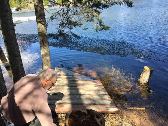 Gail Adair photoFlooding in the High Rock Road area in the community of West Hawk Lake, about 140 kilometres east of Winnipeg. Danny Adair pulls in part of a dock that broke loose and was floating in McKenzie Bay.