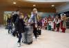 Ukrainian nationals fleeing the ongoing Russian invasion of Ukraine arrive at Richardson International Airport. (David Lipnowski / The Canadian Press)