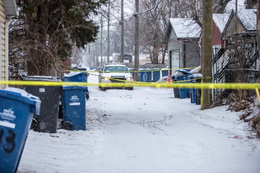 MIKAELA MACKENZIE / WINNIPEG FREE PRESS FILES
Police on the scene in the back lane of the 200 block of Lansdowne Avenue in Winnipeg on March 26, 2020.