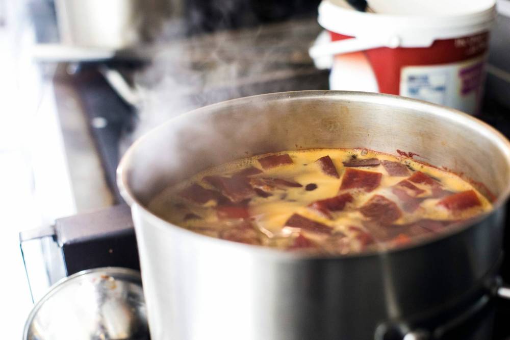 MIKAELA MACKENZIE / WINNIPEG FREE PRESS Ingredients simmer on the stove in Roger Wilton’s commercial kitchen.
