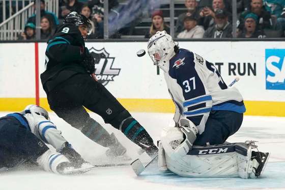 Tony Avelar / The Associated Press filesWinnipeg Jets goaltender Connor Hellebuyck will face Sharks left-winger Evander Kane (centre) tonight in San Jose.