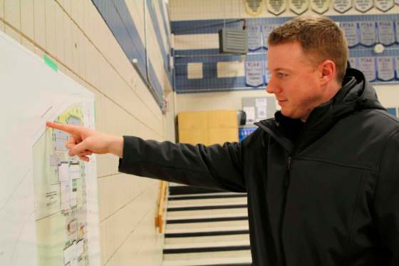 MAGGIE MACINTOSH / WINNIPEG FREE PRESSRyan McGregor, a father of two who lives in Bridgwater Forest, indicates the location of his house — across from the K-8 school that is slated to be built in Waverley West, which his kids won't be able to attend due to its catchment, during a community update meeting at Acadia Junior High School on Wednesday evening.
