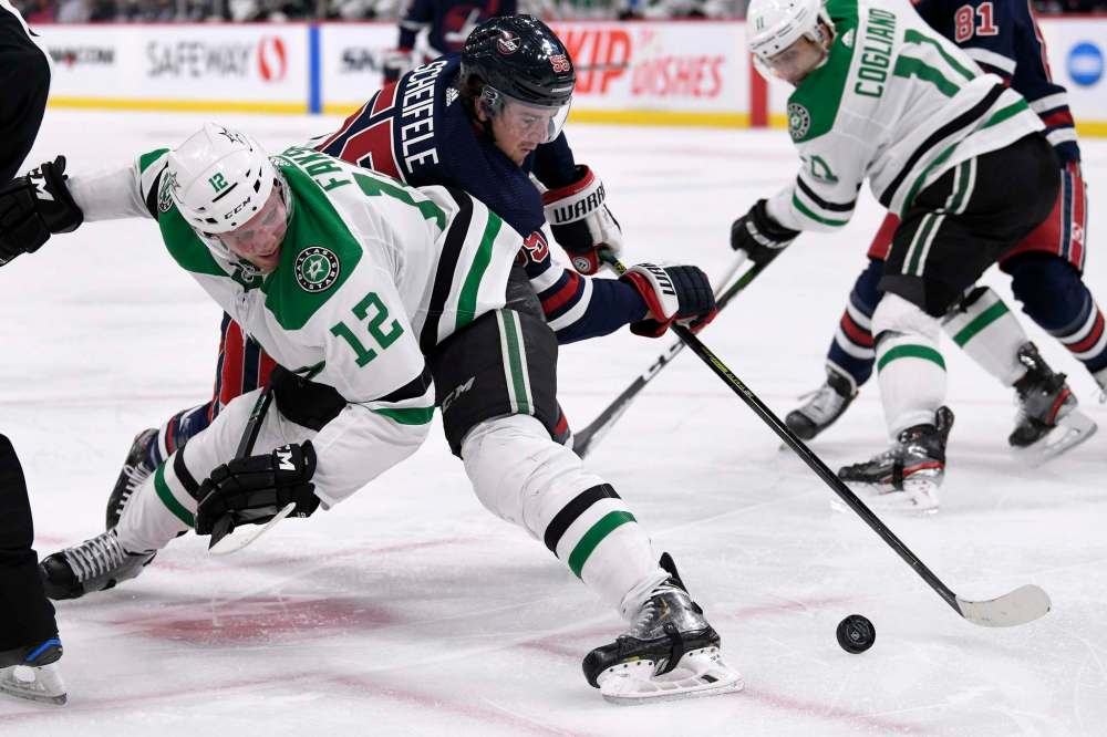 Fred Greenslade / The Canadian Press
Jets forward Mark Scheifele tries to work the puck past Stars forward Radek Faksa during Tuesday night’s NHL Central Division tilt at Bell MTS Place.