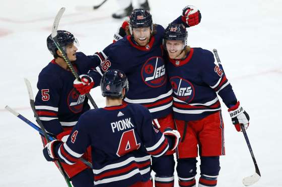 JOHN WOODS / WINNIPEG FREE PRESSWinnipeg Jets’ Luca Sbisa, Neal Pionk, Blake Wheeler and Nikolaj Ehlers celebrate Ehlers’ goal against the Dallas Stars during the first period in Winnipeg on Tuesday.