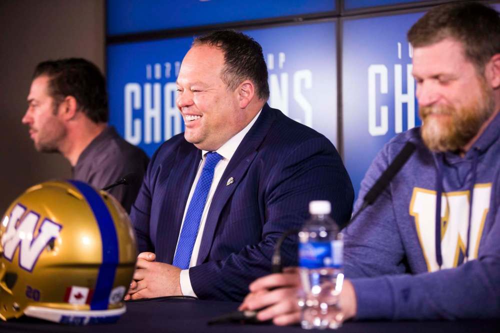 MIKAELA MACKENZIE / WINNIPEG FREE PRESS
Blue Bombers president and CEO Wade Miller (centre), general manager Kyle Walters (left) and head coach Mike O’Shea speak to the media at IG Field in Winnipeg on Friday.