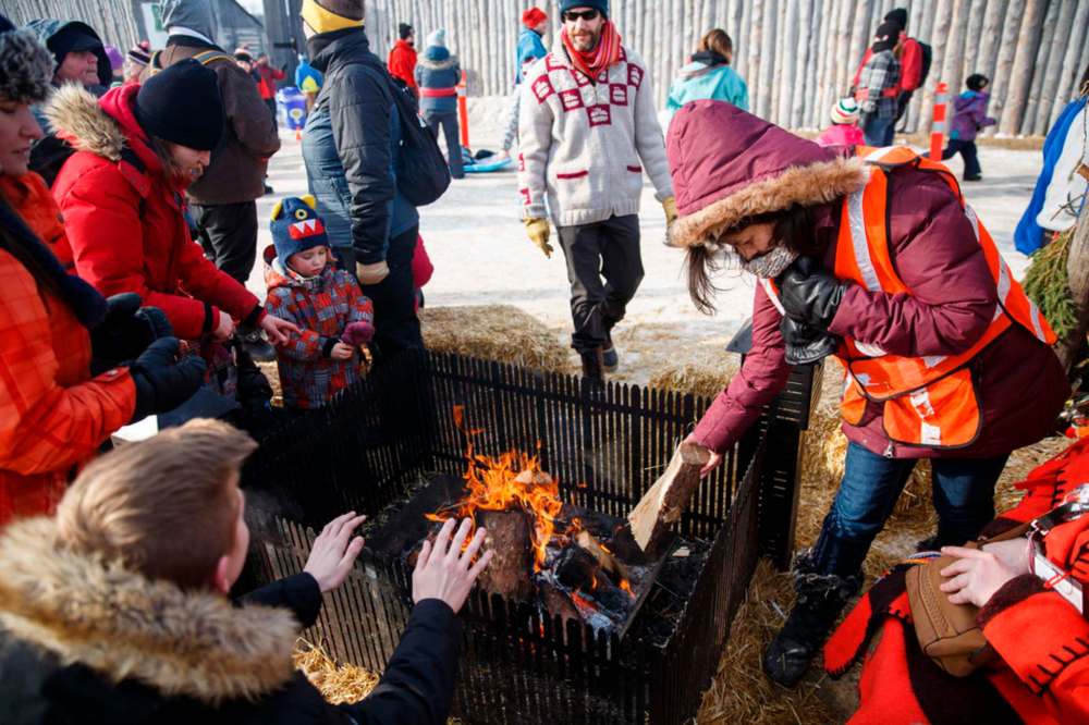 The communal fires scattered throughout Whittier Park and Fort Gibraltar during Festival du Voyageur always manage to draw a crowd. (Winnipeg Free Press files)