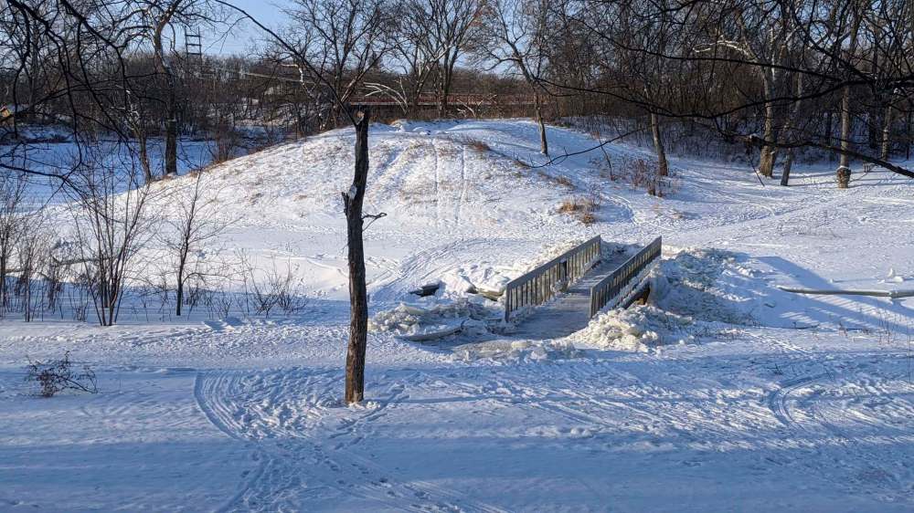 The footbridge over Omand's Creek in a Wolseley park was cleared of ice on the weekend. The city had said it would remain closed until the spring because its workers couldn't clear the ice. So some citizens took matter into their own hands and removed the hazardous ice themselves. Solomon Israel / Winnipeg Free Press