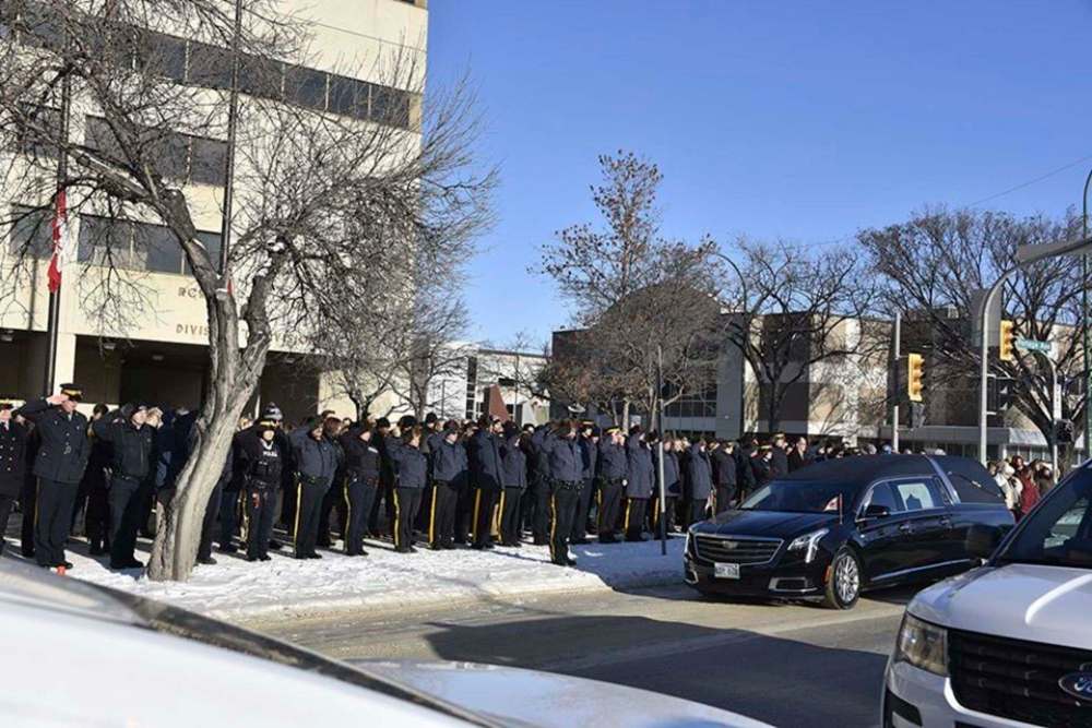 On Tuesday, a motorcade of RCMP vehicles paused in front of D Division headquarters on Portage Avenue in a moment of silence as rows of officers lined up outside, saluting as the motorcade passed. (Facebook / RCMP)