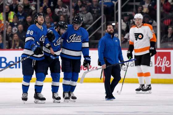 Fred Greenslade/ The Canadian PressWinnipeg Jets' Mathieu Perreault is helped off the ice by teammates Nathan Beaulieu and Andrew Copp after being injured against the Philadelphia Flyers during on Sunday.