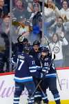 John Woods / The Canadian Press
Winnipeg Jets’ Adam Lowry (from left) celebrates Andrew Copp’s game-winning goal last month with Mathieu Perreault.