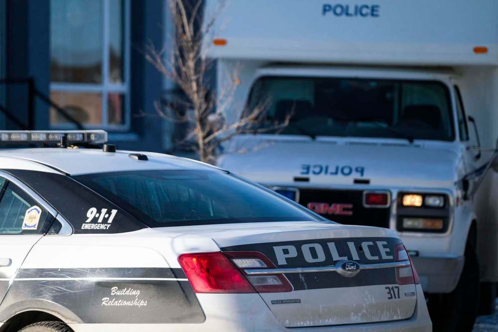 Police work the scene of the city's 44th homicide on Saturday. A man in his 50s was stabbed to death in a townhouse on Highwater Path. (Daniel Crump / Winnipeg Free Press)