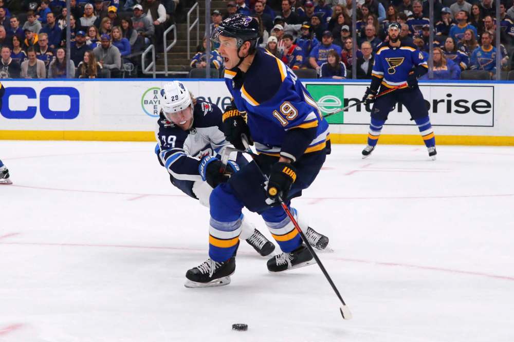 St. Louis Blues defenceman Jay Bouwmeester (19) looks to pass the puck against Winnipeg Jets' Patrik Laine (29) during the first period of an NHL hockey game Sunday in St. Louis. (Dilip Vishwanat / The Associated Press)