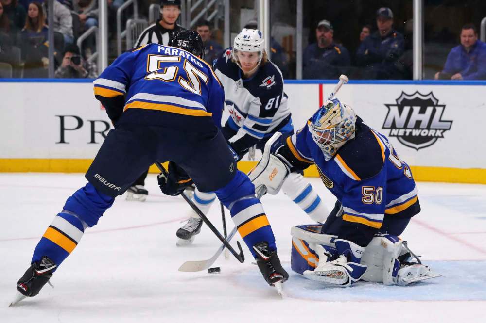 St. Louis Blues goalie Jordan Binnington (50) makes a save against the Winnipeg Jets during the first period of an NHL hockey game Sunday in St. Louis. (Dilip Vishwanat / The Associated Press)