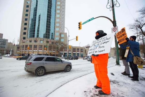 MIKE DEAL / WINNIPEG FREE PRESSLocked out Tim Horton's employees and supporters demonstrate at Portage and Main Thursday, just outside of 1 Lombard Place where the coffee shop is located in the underground shopping centre.