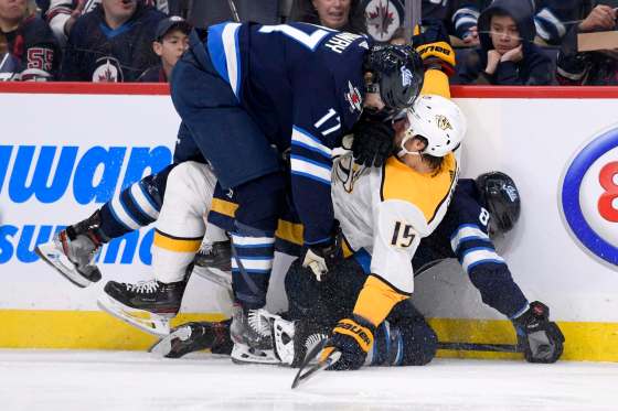 Winnipeg Jet Adam Lowry (17) and Mathieu Perreault (85) collide with Nashville Predators' Craig Smith (15) during second period NHL action in Winnipeg on Sunday. (Fred Greenslade / The Canadian Press)