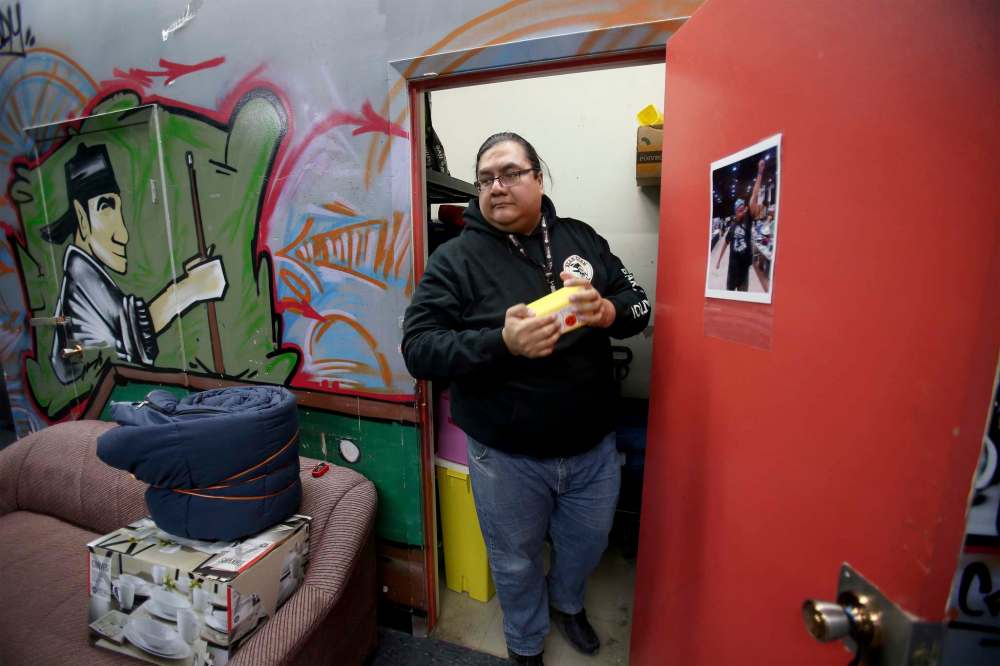 SHANNON VANRAES / WINNIPEG FREE PRESS
Travis Bighetty, co-founder of the West Broadway Bear Clan Patrol, retrieves a sharps disposal container from a supply closet as he prepares to head out on patrol with other volunteers on January 10, 2020. The group picks up used needles and other hazards as it patrols the neighbourhood.