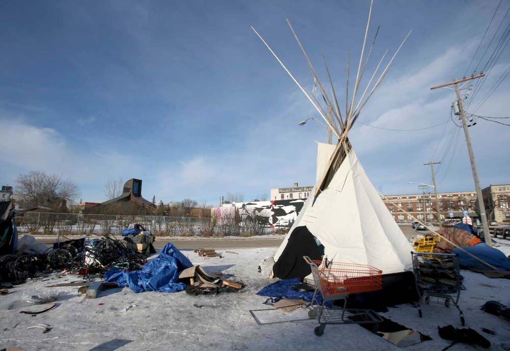 SHANNON VANRAES / WINNIPEG FREE PRESS FILES
A teepee, erected in honour of Matthew Allan Sutherland, served as a warming shelter for homeless people living in a makeshift camp near the Manitoba Metis Federation building in downtown Winnipeg until in burned down this week.