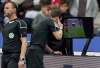 Michael Sohn / The Associated Press files
Officials check a video replay to determine whether a penalty should be assessed in German Bundesliga play.