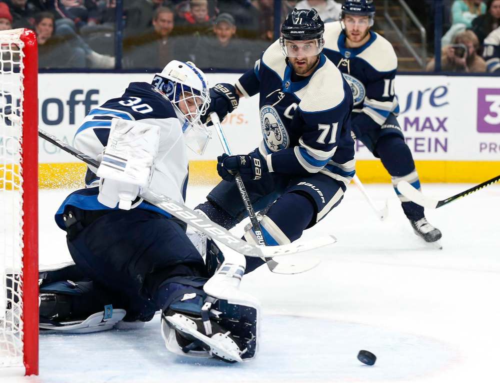 (AP Photo/Jay LaPrete)
Winnipeg Jets' Laurent Brossoit, left, makes a save against Columbus Blue Jackets' Nick Foligno during the second period Wednesday in Columbus, Ohio.