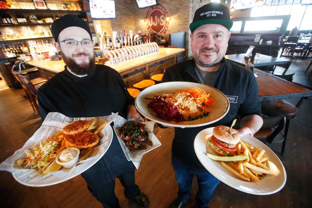 JOHN WOODS / WINNIPEG FREE PRESS
Fionn MacCool’s kitchen manager Dennis Burnett (left) and owner Jay Kilgour show off some of the many plant based, meat-like products on the menu at the restaurant.