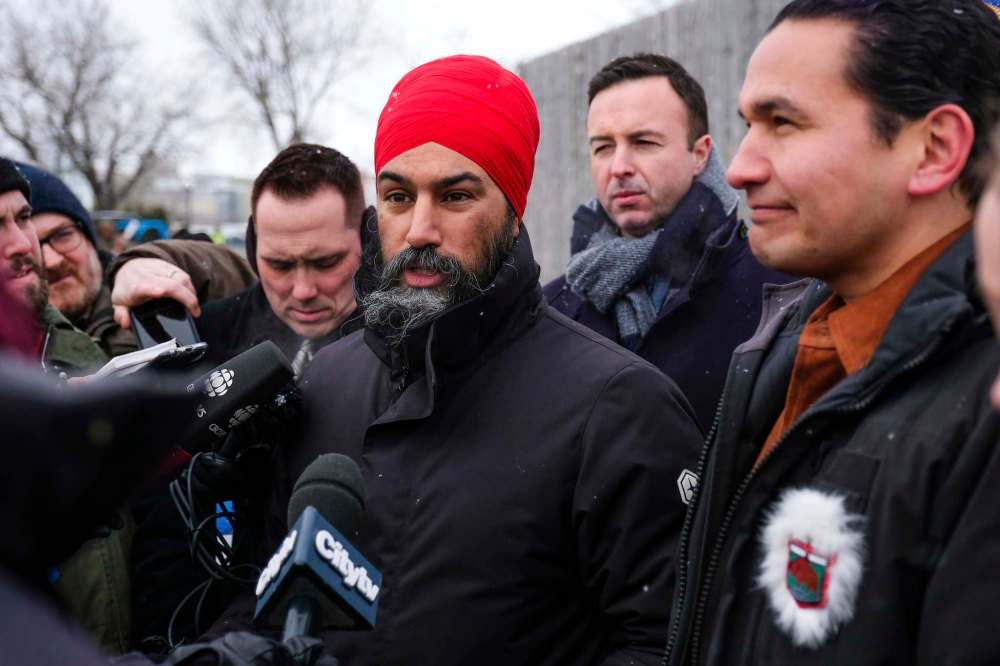 Daniel Crump / Winnipeg Free Press
Federal NDP Leader Jagmeet Singh (middle) and Provincial NDP Leader Wab Kinew (right) field questions from the media at Festival du Voyageur on Monday.
