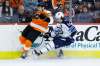 Connor Bunnaman (left) and Mark Scheifele collide during the third period. (Matt Slocum / The Associated Press)