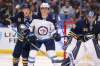 Jeffrey T. Barnes / The Associated Press
Buffalo Sabres defenseman Jake McCabe (19) and Winnipeg Jets forward Cody Eakin (20) battle for position during the second period of an NHL hockey game Sunday, Feb. 23, 2020, in Buffalo, N.Y.