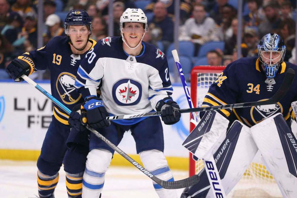 Jeffrey T. Barnes / The Associated Press
Buffalo Sabres defenseman Jake McCabe (19) and Winnipeg Jets forward Cody Eakin (20) battle for position during the second period of an NHL hockey game Sunday, Feb. 23, 2020, in Buffalo, N.Y.
