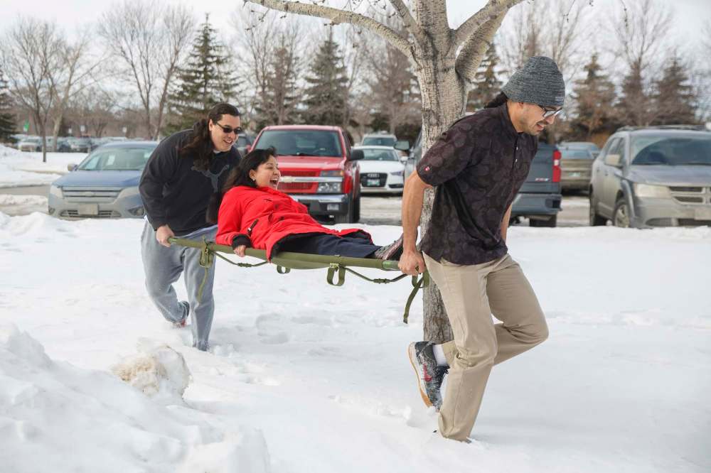 MIKE DEAL / WINNIPEG FREE PRESS
Red River College students Sean Rayland-Boubar (left) and Mark Montour (right) carry Carla Kematch, the college’s Truth and Reconciliation manager, during the moose haul competition.