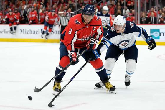 (AP Photo/Nick Wass)Washington Capitals left wing Alex Ovechkin and Winnipeg Jets defenceman Dmitry Kulikov reach for the puck during the second period Tuesday in Washington.