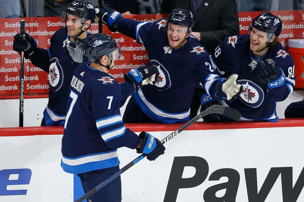 Dmitry Kulikov (7), Anthony Bitetto (2) and Nathan Beaulieu (88) celebrate Kulikov's goal during the first period. (John Woods / The Canadian Press)