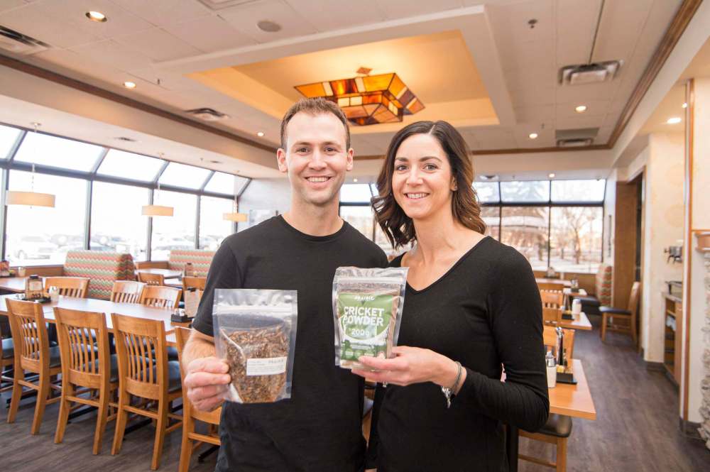 Prairie Cricket Farms owners Ryan and Lesley Steppler, show off packages of roasted crickets and cricket powder.