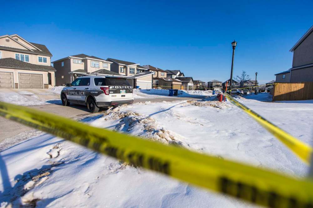 A large section of Kowalsky Crescent was taped off Tuesday morning after an officer shot a man outside a residence. (Mikaela MacKenzie / Winnipeg Free Press)