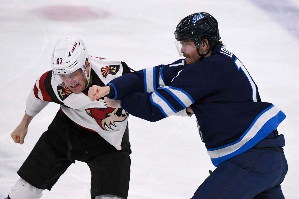 THE CANADIAN PRESS/Fred Greenslade
Winnipeg Jets' Adam Lowry fights Arizona Coyotes' Lawson Crouse during the first period in Winnipeg on Monday. Lowry brought a physical presence with him in his return to the Jets lineup Monday after missing 20 games with an upper body injury.