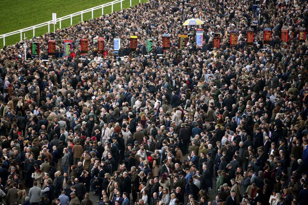 Don't stand so close to me: people in the crowd at the Cheltenham Festival in England are not practising good social distancing by being closer than a metre apart. (Tim Goode / PA)