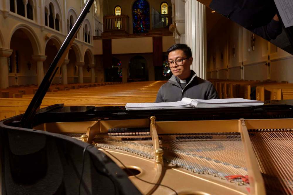 JESSE BOILY / WINNIPEG FREE PRESS
Rev. Geoffrey Angeles sits at the piano to an empty church on Thursday, March 19, 2020.